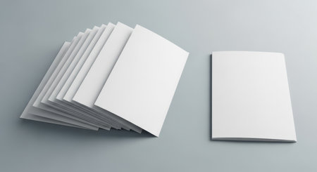 Blank white books and notebooks on gray background.の素材