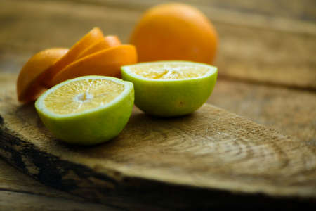 sliced fruits on wooden table.(citrus fruits)の写真素材