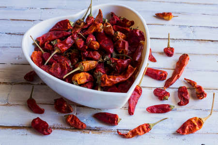 Dried chili pepper on wooden white background.の写真素材