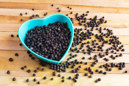 black pepper on wooden background.の写真素材