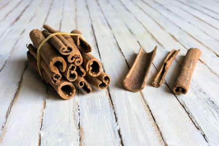 Cinnamon sticks on old rustic background.の写真素材