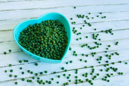Green peppercorn on old white wooden background.の写真素材