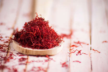wooden spoon full of dried saffron on rustic background, soft focus.の写真素材