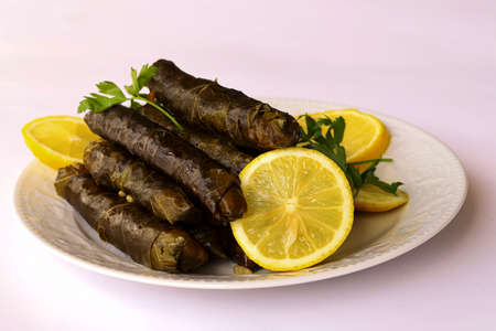 leaf wrap, vine leaf, traditional food, isolated on white, dolmades, sarmale, stuffed, lemon slices, appetizerの写真素材