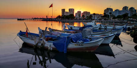 Turkey / Izmir / KarÅÄ±yaka 15 August 2020 boats at sunset in fishing shelter and houses in MaviÅehir.のeditorial素材