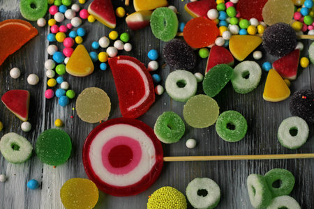 Colorful candies on wooden background