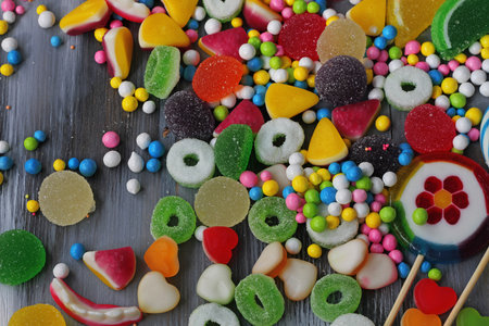 Colorful candies on wooden background