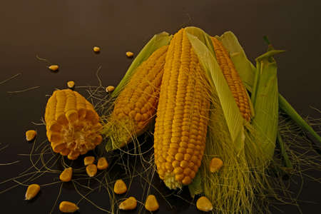 Fresh corns on black glass table.の写真素材
