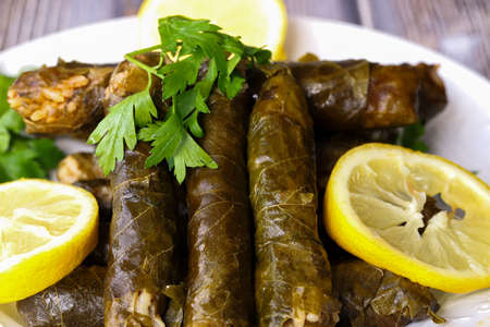 leaf wrap, vine leaf, traditional food, isolated on white, dolmades, sarmale, stuffed, lemon slices,...