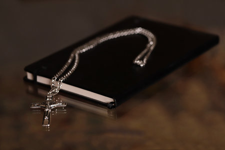 Holy book and cross on black backgroundの写真素材