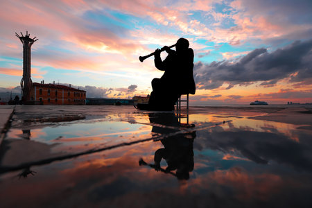 People walking around in Turkey -Izmir - Cumhuriyet square at sunset, silhouettes, reflect.の写真素材