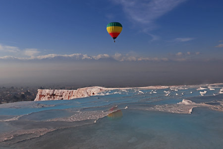 Turkey - Natural wonders in Denizli, Pamukkale travertines and balloons carrying people.の写真素材