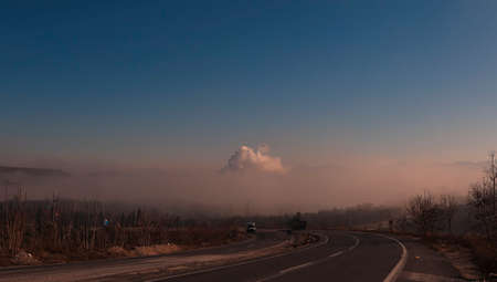 (Mugla - Turkey) Milas-Yatagan road, smoke from the facility's pipe, release of harmful gases to the atmosphere, greenhouse effectsの写真素材