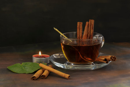 aromatic hot cinnamon tea on wooden tableの写真素材