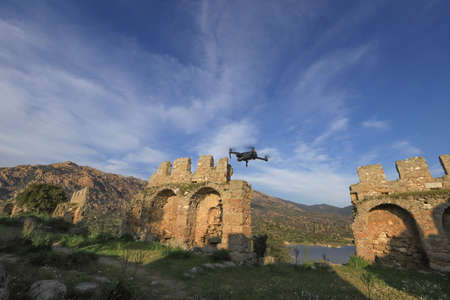 drone helicopter flying with digital camera in mountainsの写真素材