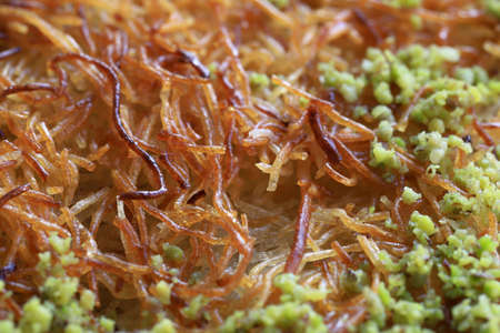 Turkish dessert kunefe, kunafa, kadayif with pistachio powder and cheese, served hot, very sweet. Turkish traditional dessert.の写真素材