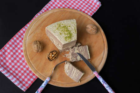 black background. Chocolate halva on wood.