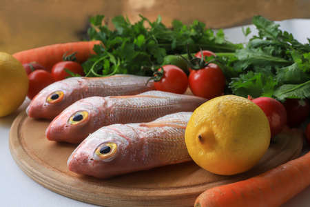Fresh coral fish ( Pagellus erythrinus ) on wooden backgroundの写真素材