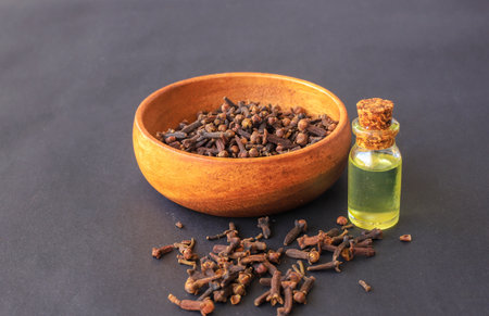 Black background black pepper essential oil. Chili oil bottleの写真素材