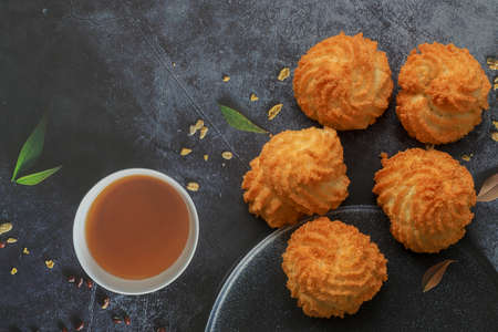 Flourless homemade fresh delicious coconut cookies with golden crust in a white plate.の写真素材