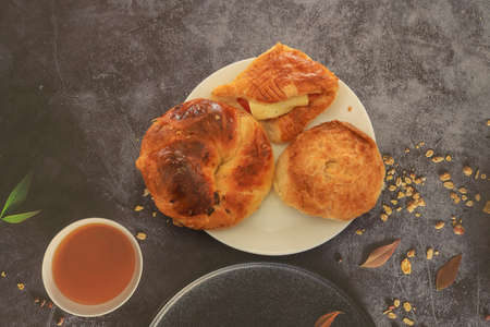 Pie with tomato and cheese in a white plate, open and boyoz