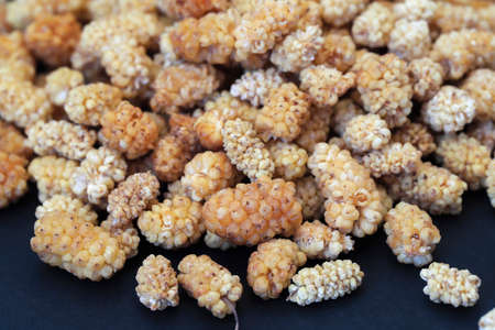 Dried white mulberry on black backgroundの写真素材