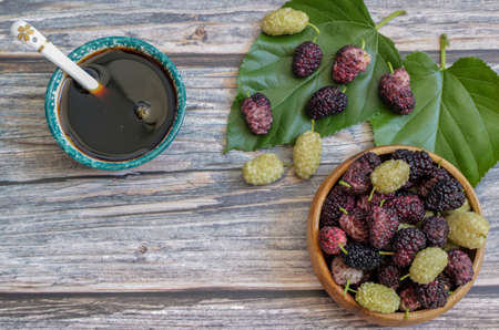 Domestic fresh mulberry molasses on a rustic wooden boardの写真素材