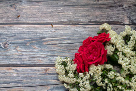 Wooden background, Christmas concept white flowers ,red roses . Top view flat lay isolated background with copy space for christmas wallpaper.の写真素材