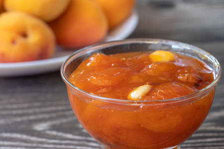 Apricots on the table and apricot jam in a glass bowl.の写真素材