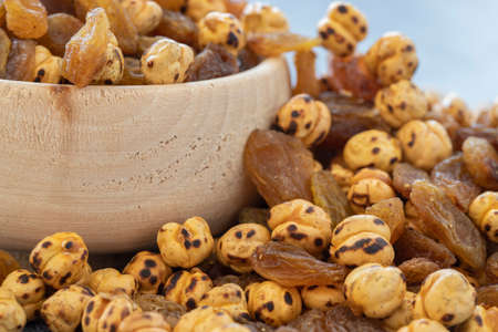 Yellow chickpeas and grapes on gray background.の写真素材