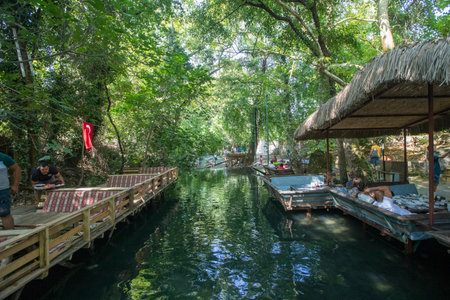 Turkey - Mugla -Koycegiz 27 August 2022 A beautiful place where people have resting areas on the YuvarÃ§ay (River).のeditorial素材