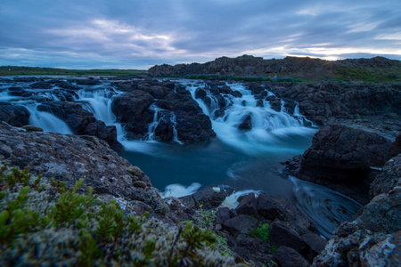 Majestic summer sunrise on Bruarfoss Waterfall. The 'Iceland's Bluest Waterfall.' Blue water flows...