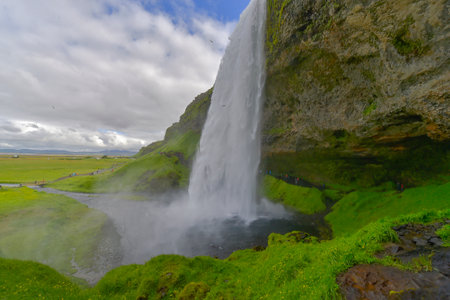 Seljalandsfoss waterfall with the rainbowの写真素材