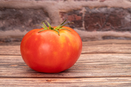 Red, fresh Tomatoes (Solanum lycopersicum) on wooden backgroundの写真素材