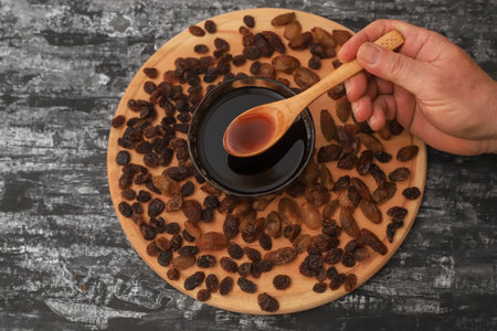 Grape molasses and dried sultaniye organic grapesの写真素材