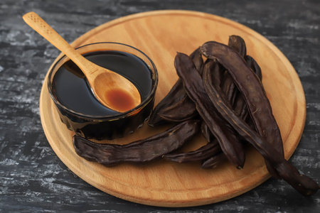 Carob ( Carob ) Molasses on white backgroundの写真素材