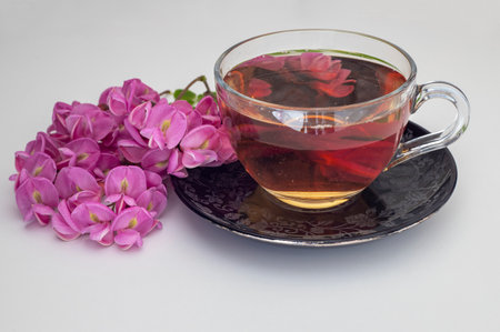 Lilac colored Acacia flower tea on a white backgroundの写真素材