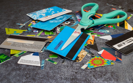 Izmir - Turkey circa 2022. pile of old expired credit cards smashed isolated on gray tabletop - protection against identity theft conceptのeditorial素材