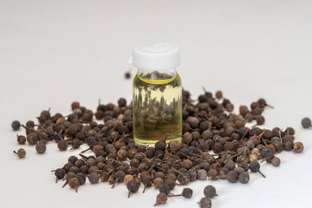 Cube pepper oil (Piper cubeba) on a white background. Turkish name ( Kebabiye oil )