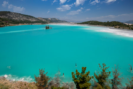 Blue pond (Ash pond) consisting of burned coal ashes in the thermal power plant in the Yatagan district of Mugla provinceの写真素材