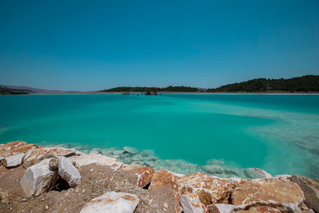 Blue pond (Ash pond) consisting of burned coal ashes in the thermal power plant in the Yatagan district of Mugla provinceの写真素材