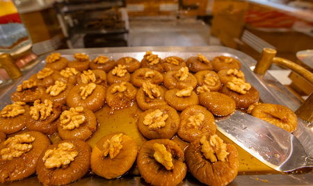 Stuffed dry fig dessert, cooked with syrup, traditional, pistachio and kaymak (Turkish name; Cevizli...