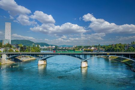 Skyline of Basel's old town with the Basler Minster and Wettstein Bridge in the foreground on a blue cloudy spring day. The photo was taken on August 27, 2015 in Basel, Switzerland.の写真素材