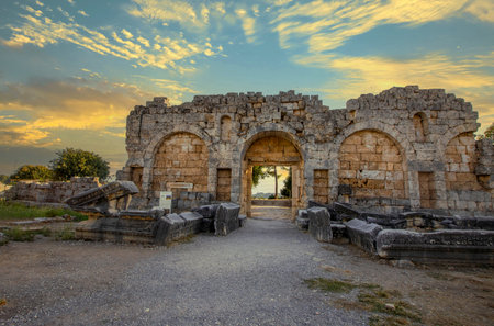 Scenic ruins of the nymphaeum (nymphaion) in Perge (Perga) at Antalya Province, Turkey. Awesome view of the ancient Greek city. Perge is a popular tourist destination in Turkey.の写真素材