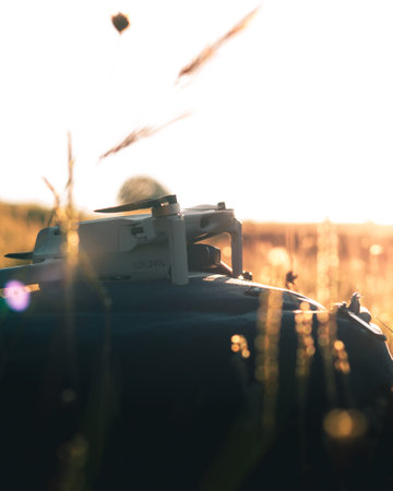 Silhouette of a drone in the field at sunset.の写真素材
