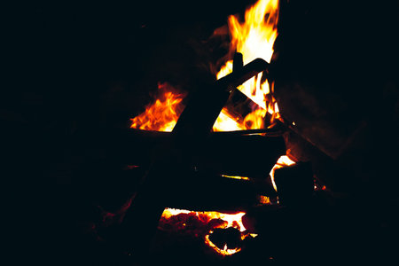 Burning wood in a campfire. Selective focus. Toned.の写真素材