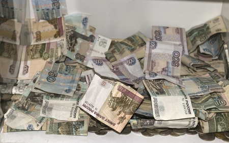 Wealth, many Russian money. Rubles. The money accumulated in a glass boxの写真素材