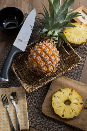 pineapple ftuit and slices on the table.