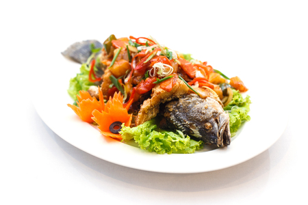 fried fish with sweet and sour sauce on white backgroung. Thai food style.の写真素材