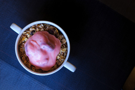 Top view, granola and strawberry yogurt in a cup.の写真素材